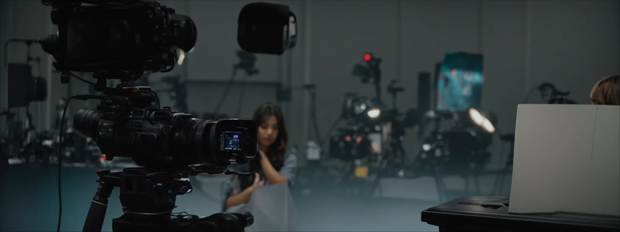 a videographer captures a product demonstration in a well-lit studio.