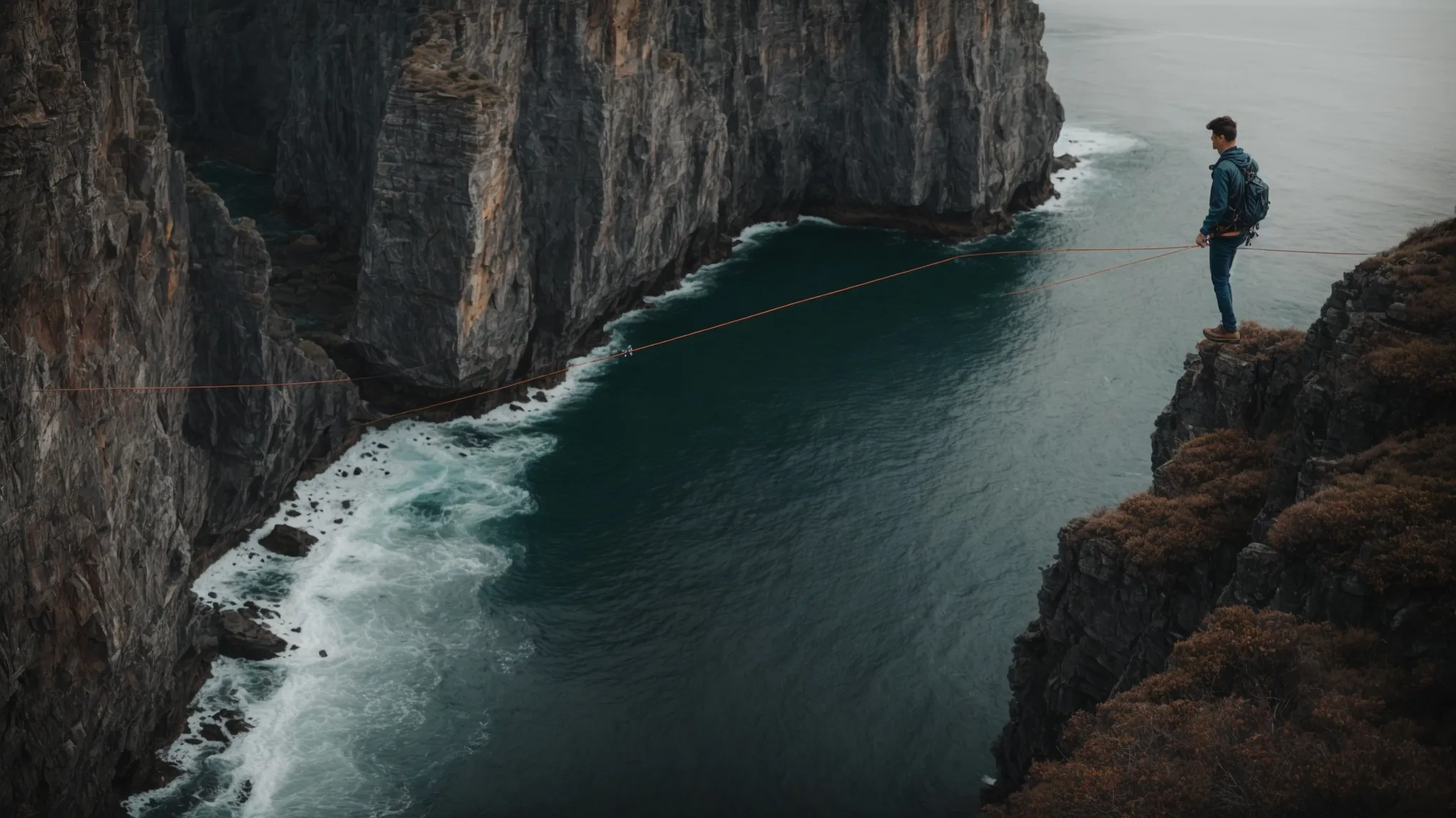 a person on a tightrope between two cliffs, symbolizing the balance between following a passion and making practical decisions.