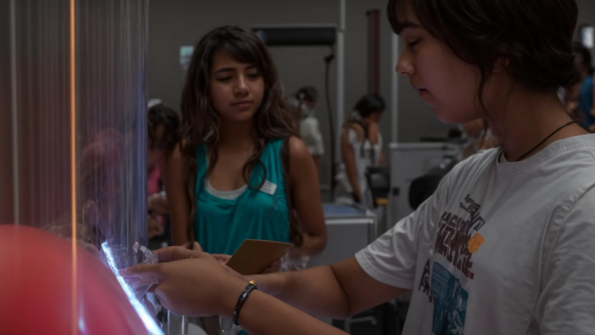 a student and instructor explore an interactive exhibit together at a science summer camp.