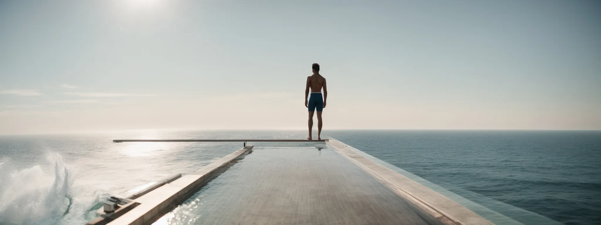 a person poised at the edge of a diving board, overlooking a vast, sunlit ocean, symbolizes the plunge into the expansive world of keyword research.
