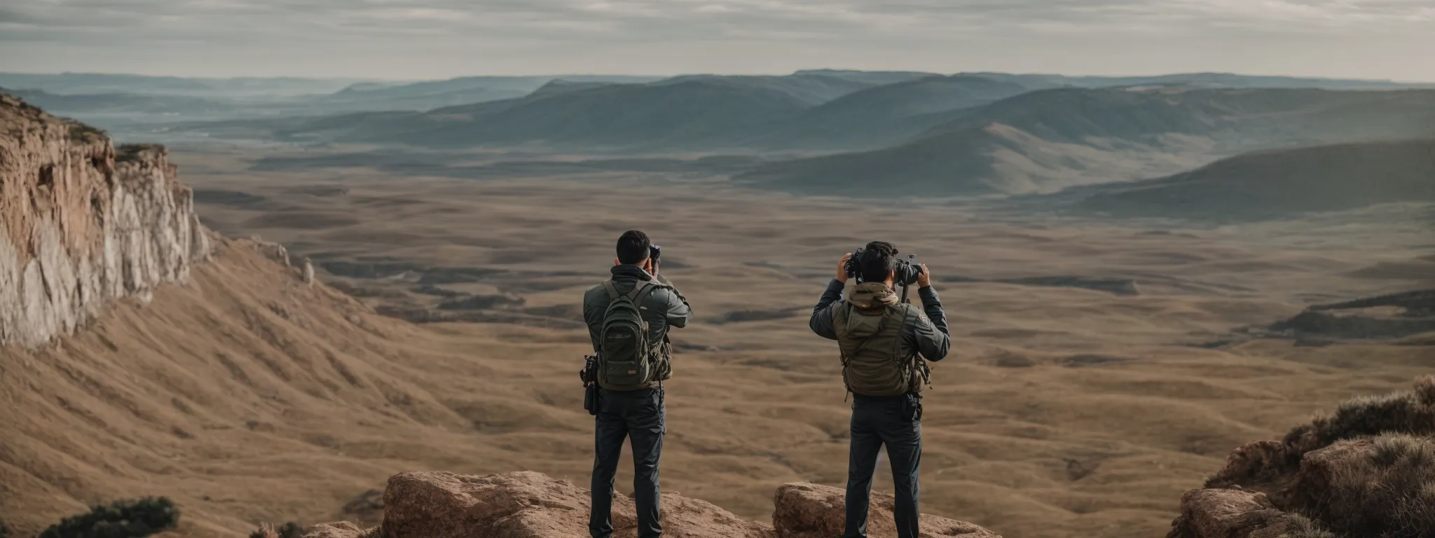 a person standing on a cliff with binoculars overlooking a vast landscape where digital representations of seo metrics and competition are integrated into the horizon.