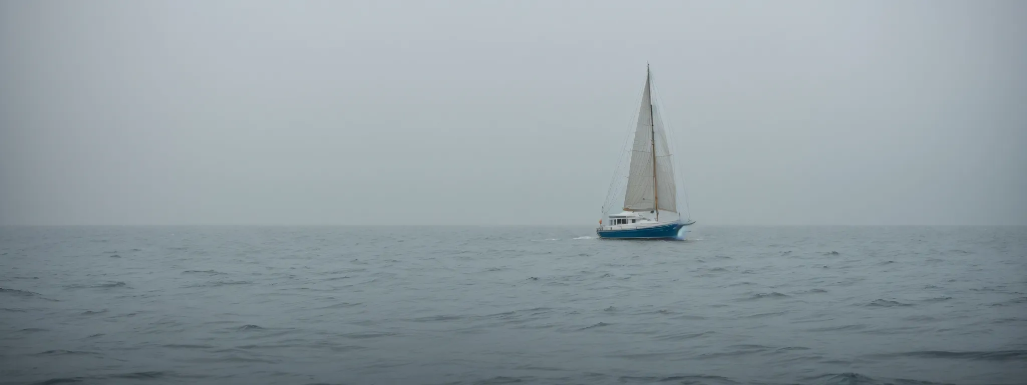 a small sailboat navigates through a foggy sea, symbolizing the strategic journey of small businesses through the complexities of keyword search volume and competition.