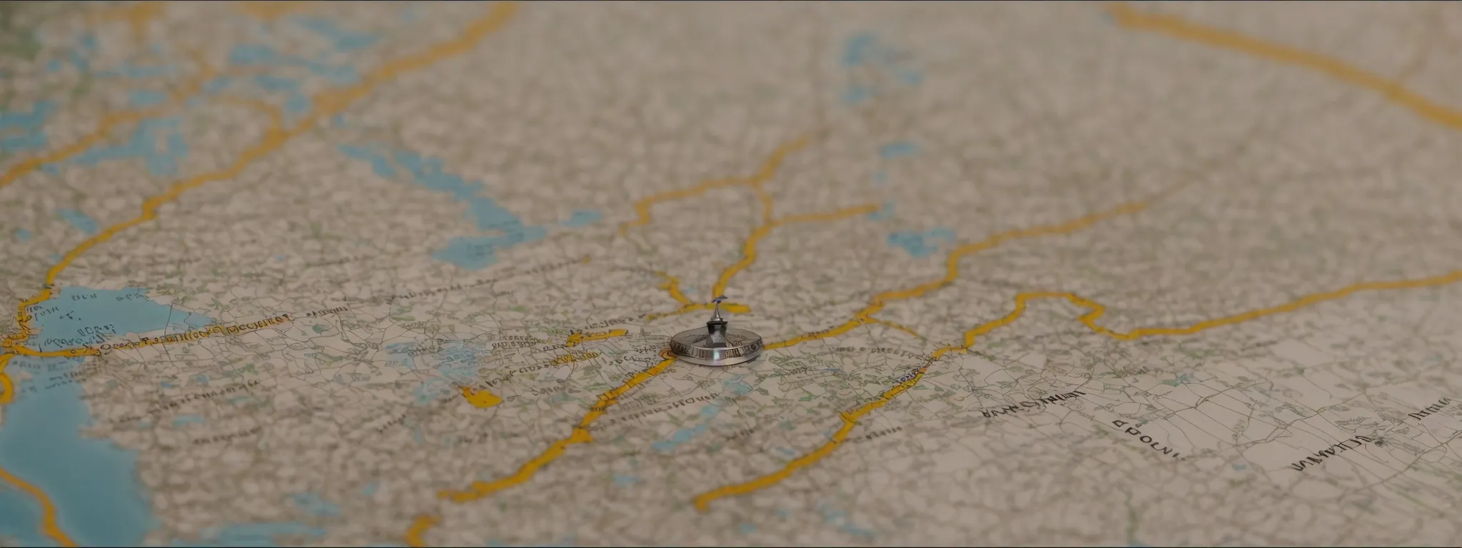 a compass lying on a map, highlighting a strategic route through uncharted territories.