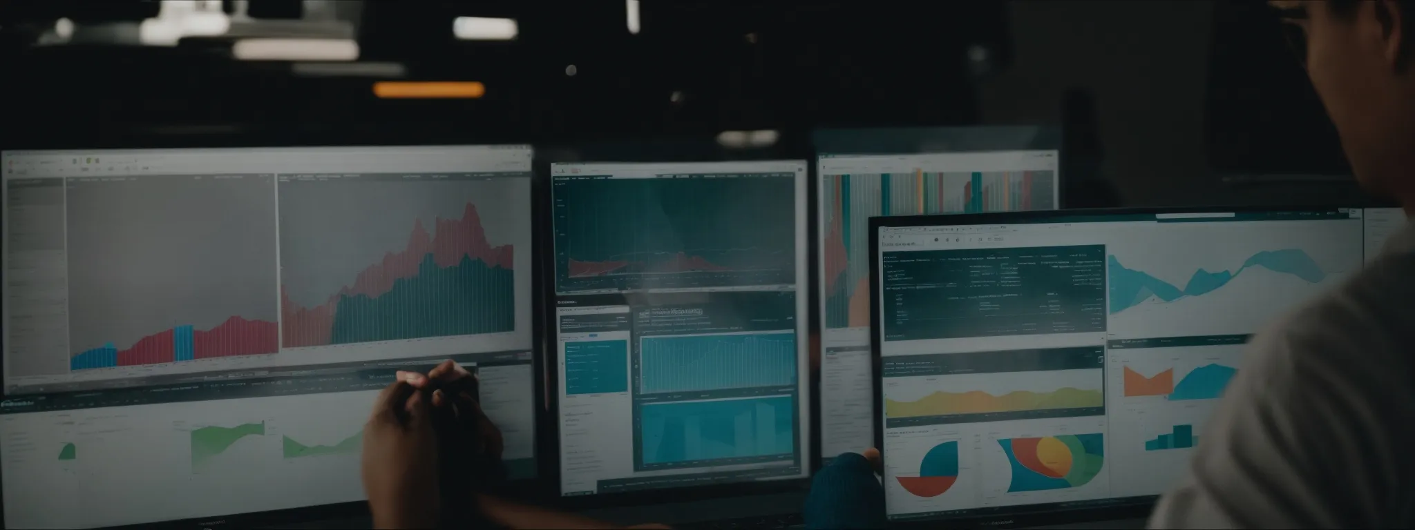 a marketer analyzing data charts on a computer screen, exploring searchatlas's software features.