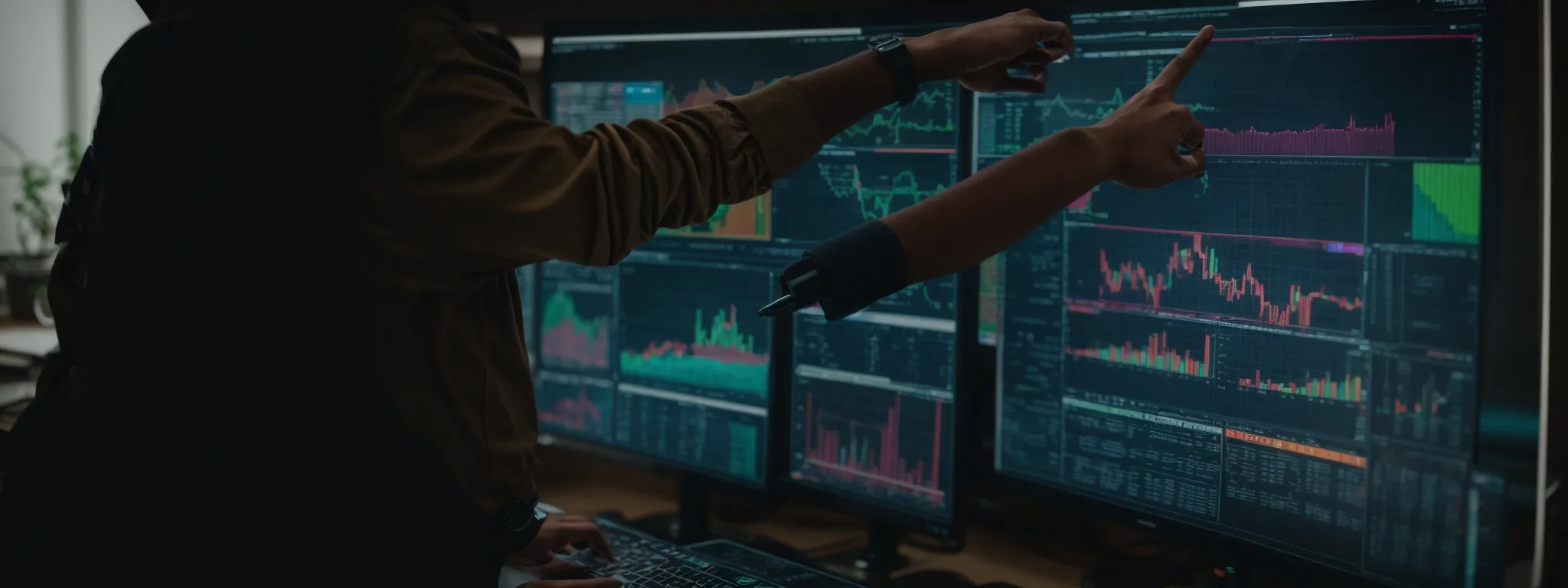 a person pointing at a computer screen displaying colorful charts and graphs tracking seo metrics.