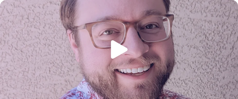 A smiling person with glasses and a beard, featuring actionable changes and a play button indicating a video overlay to boost SEO and get traffic.